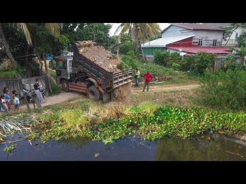 Small Project working in one day !! dump truck and by mini bulldozer Komatsu push soil rock clear