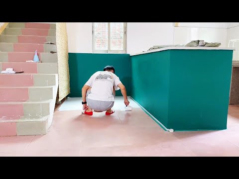 A young couple artistically remodels and paints the walls of a dilapidated house