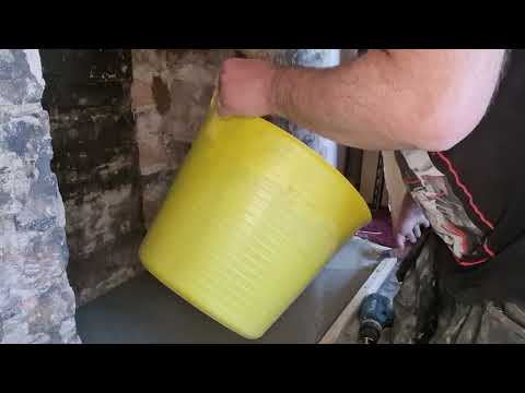 Part 3 of the fireplace videos mixing and pouring self levelling cement for fireplace.