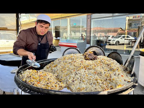 Popular Uzbek pilaf in a big pot l Street food in Uzbekistan