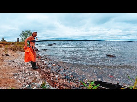 Woman waits out a small storm on a lake alone in an abandoned cabin