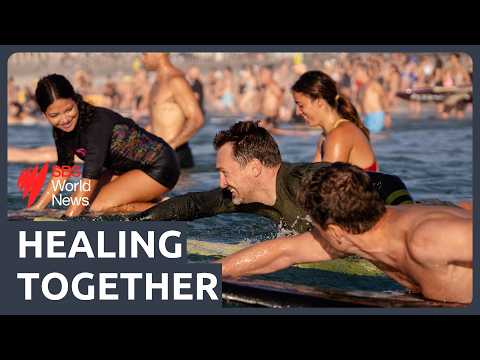 Bondi Beach shooting: Hundreds gather on sand and surf to honour the victims and first responders