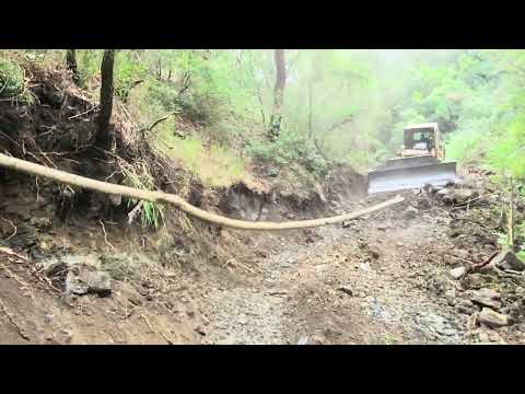 CREATING A ROAD WITH A BULLDOZER IN A GREEN FOREST COMPLETELY CLOSED ROCKY AND STONY AREA CAT D7G