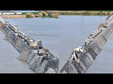 Today, many stone trucks are waiting in a row to build a road around the lake and push the stones
