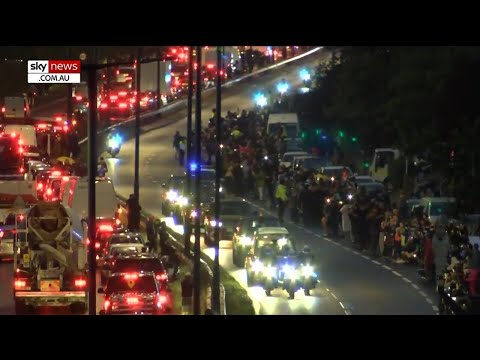 Thousands line London's streets to see Queen's coffin arrive