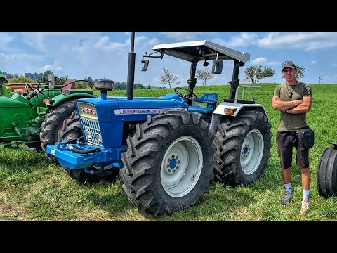 Exhibition of OLD machinery in Switzerland. Tractors plowing in the field