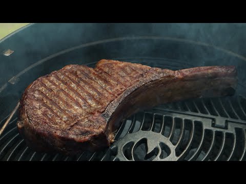 Juicy and tender! Grilled Tomahawk Steak Barbecue cooking outdoors in the countryside