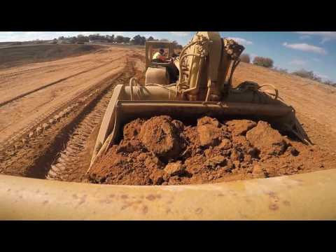 Operating Cat 627 Scraper from cut area to fill area