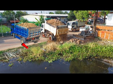 Huge delete pond by skill dozer push soil the deep water and Nissan trucks