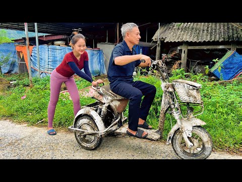 The girl repaired and restored the entire of the old electric bicycle.
