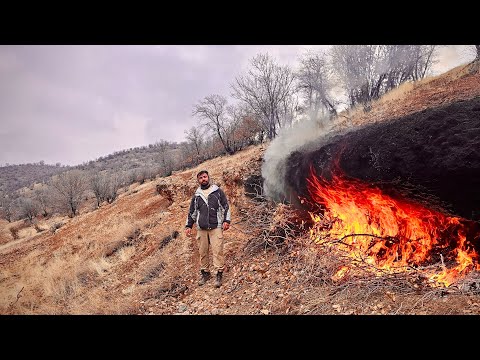 Fire Carving a Survival Shelter in Extreme Cold.Building Stone Shelter with Fireplace in Rainstorn