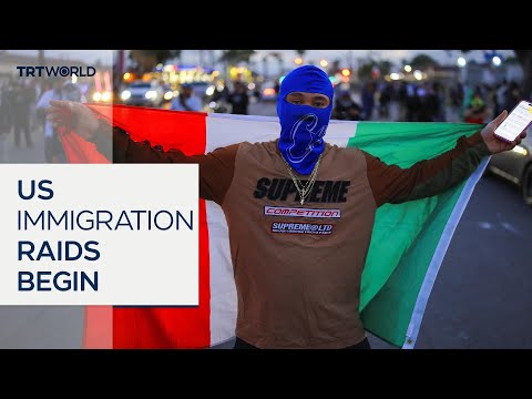 Crowds clash with US federal agents after dozens detained in raids