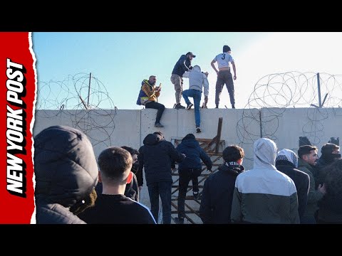 Wild Footage Shows Pro-Kurdish Protesters Storming Border Wall Into Syria