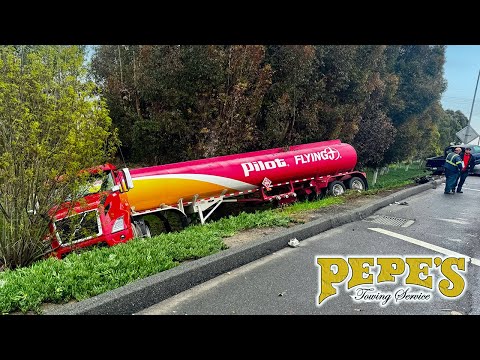 Fuel tanker swerves off freeway - lands down embankment