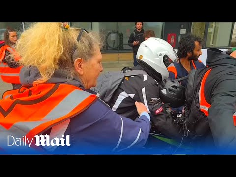 Angry motorcyclist ploughs through Just Stop Oil protest in London as tensions rise