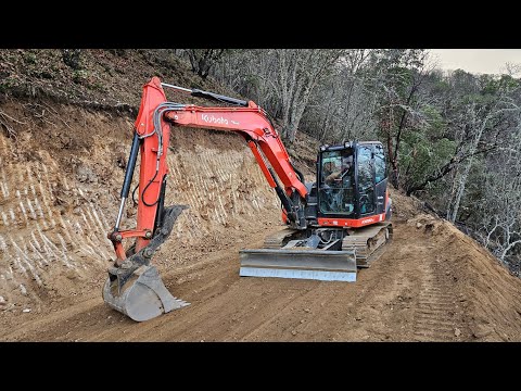 Steep road cleanup before moving on with the Kubota KX 080 4 excavator