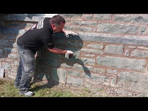 Finishing lime mortar off using a piece of wood, then a churn brush