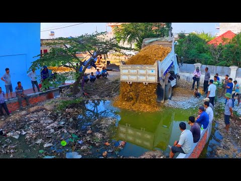 Nicely project Dump Truck Dumping Soil to Fill Land in the Village with Old bulldozer Push soil