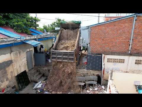Bulldozer destroy the old home and fill up the soil