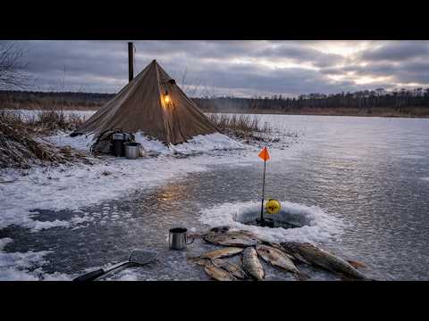Winter ice fishing for pike - camp on the ice, hot tent and blizzard