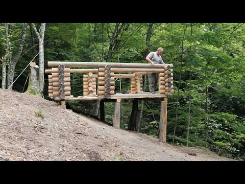 Built a House of Logs on a Large Slope in the Middle of the Forest