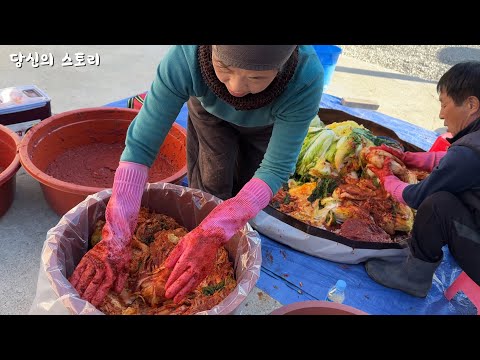 Korean rural couple having fun making kimchi.