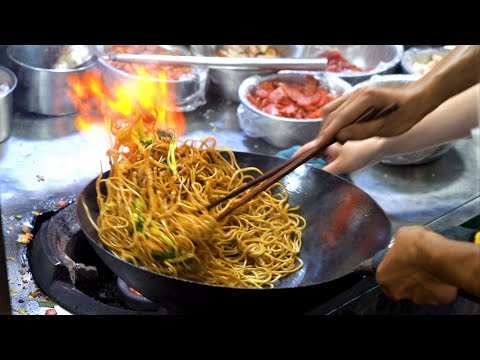 Chinese Street Food -Fried noodles with egg fried rice, fried broiler, egg and vegetable pie