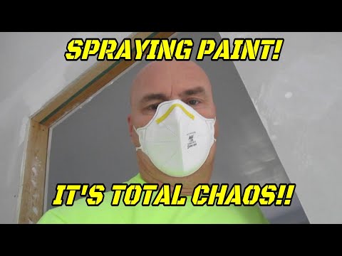 Painting ceilings with an airless sprayer.