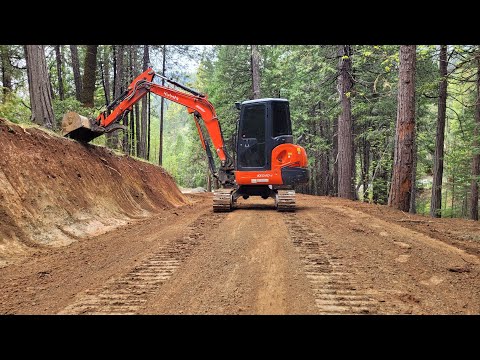Stumps, slopes and road with the Kubota KX-040