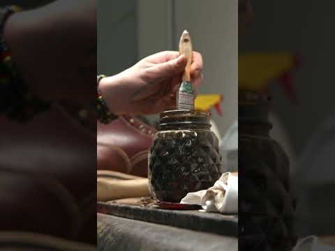 Carefully trimming, sanding, and staining the leather edge to finish off this pair of Archer's