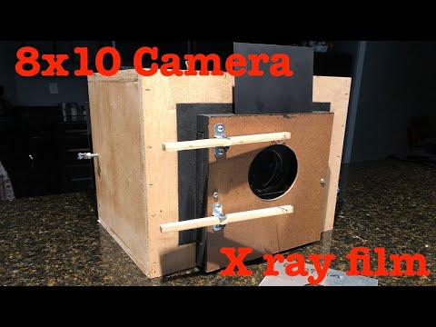 8x10 large format camera, magnifying glass lens, x-ray film and caffenol developer.