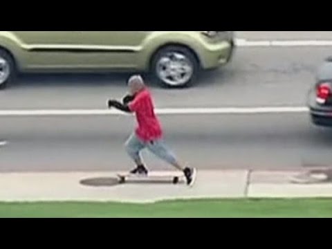Man tries to flee from a car chase on a longboard
