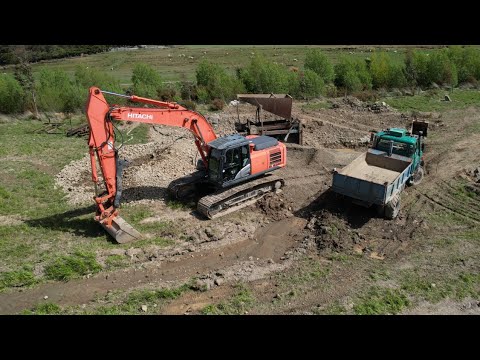 Screening gravel for farm roads and drains.