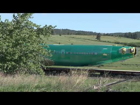 Coal train gets chased up Mullan Pass by a manifest in a race to the tunnel, Montana USA
