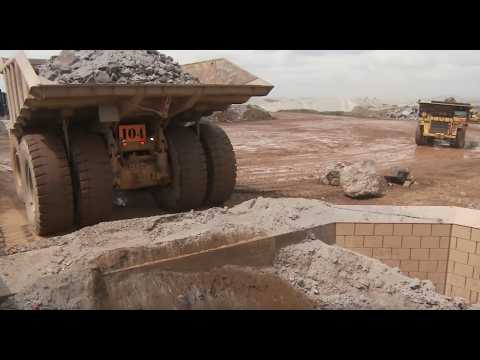 GIANT TONKA TRUCK DUMPING IN THE IRON ORE CRUSHER #caterpillar #dumptruck Crusher
