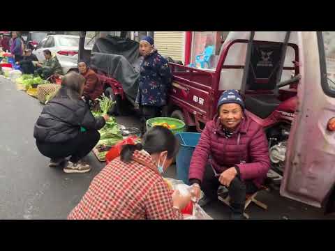 The Dong ethnic minority was at the morning market; the streets were crowded, and ginseng was as ...