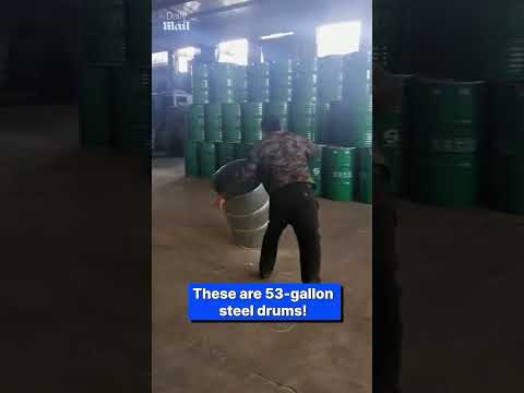 Factory worker hurls steel drums with amazing accuracy
