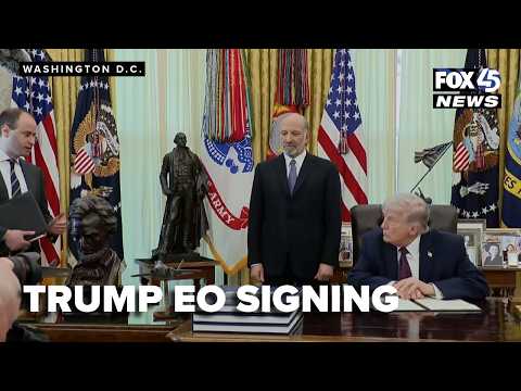 Trump signs an Executive Order in the Oval Office