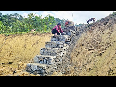 The strength of the girl who built steps down to the fish pond using natural blue stones.