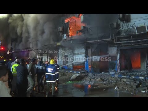 Massive fire engulfs dozens of shops at a shopping mall in southern Pakistan, killing 3 people