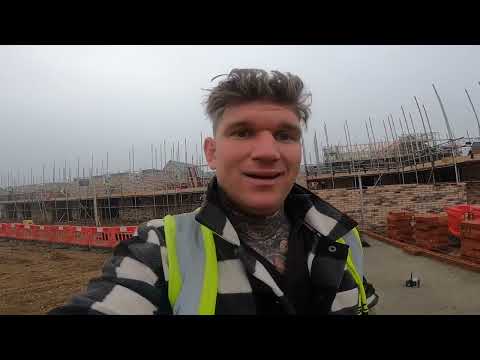 Bricklayer and his improver building a single garage