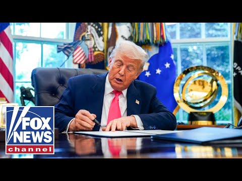 President Trump signs an executive order in the Oval Office