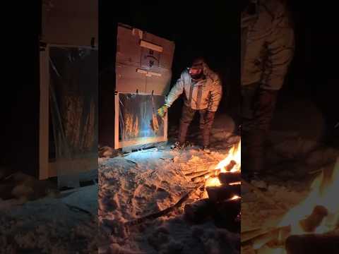 Camping out in a cardboard box shelter I pulled into the woods with a sled