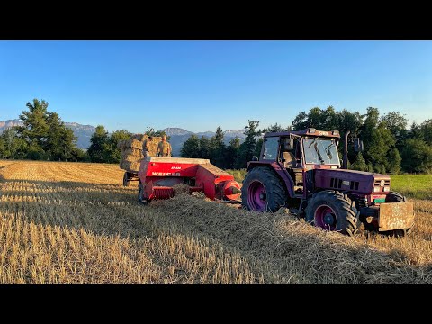 Grandfather entrusted HIS TRACTOR and BALANCE PRESS! Ukrainian man baling straw on a farm in Swit...