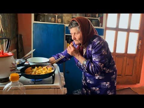 Hard life in the mountains. An elderly grandmother 86 years old, lives alone in the village