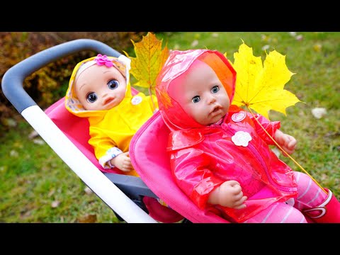 Baby Annabell doll & Baby Alive doll can't share rainy boots and a raincoat before going for a walk.