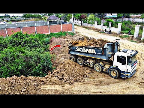 Powerful Komatsu D58E Bulldozer Pushes soils and fill in forests with 25ton dump truck pouring soils