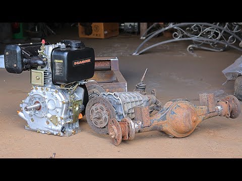 We install the walk-behind tractor engine, gearbox, and axle on the excavator frame.