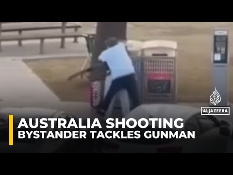 Video shows bystander tackling and disarming one of the shooters at Sydney’s Bondi Beach