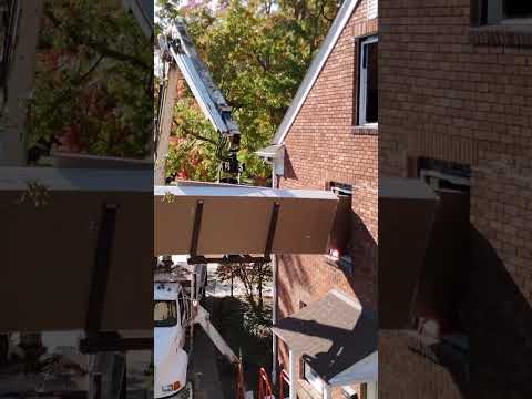 Streamlining drywall installation by loading via crane through the windows of our Lakewood project